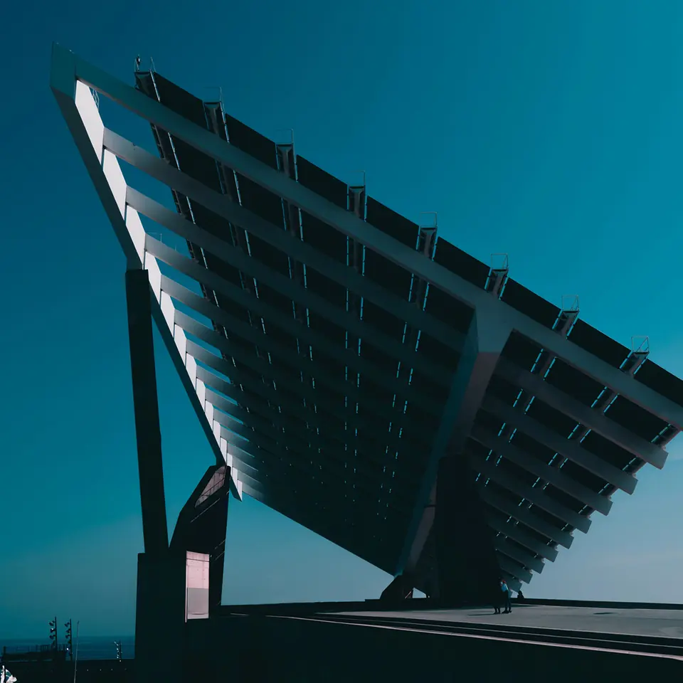 A solar canopy angled against a deep blue sky