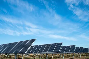 Ground-mounted solar panels under a blue sky