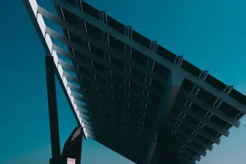A solar canopy against a deep blue sky