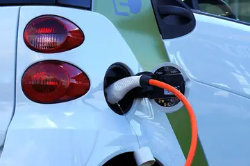 A charging cable plugged into an electric car